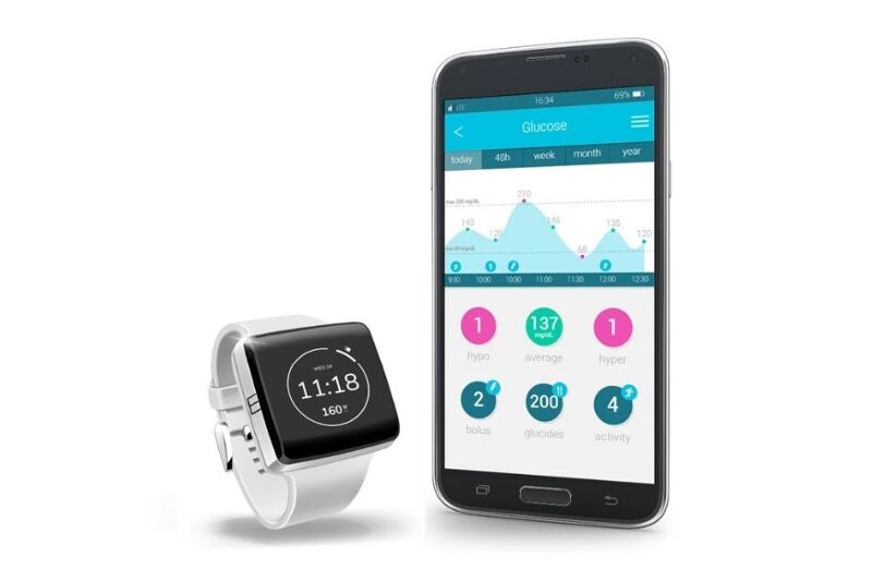 Man sieht die K’Watch neben einem Handy.